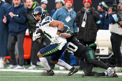 Dec 1, 2024; East Rutherford, New Jersey, USA; Seattle Seahawks wide receiver Jaxon Smith-Njigba (11) runs with the ball after a catch and is tackled by New York Jets cornerback Michael Carter II (30) during the third quarter at MetLife Stadium. Mandatory Credit: Mark Smith-Imagn Images