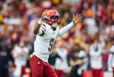 Sep 29, 2024; Glendale, Arizona, USA; Washington Commanders quarterback Jayden Daniels (5) celebrates a touchdown against the Arizona Cardinals at State Farm Stadium. Mandatory Credit: Mark J. Rebilas-Imagn Images