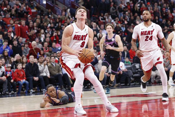 Jan 29, 2026; Chicago, Illinois, USA; Miami Heat guard Pelle Larsson (9) drives to the basket past Chicago Bulls forward Isaac Okoro (35) during the second half at United Center. Mandatory Credit: Kamil Krzaczynski-Imagn Images
