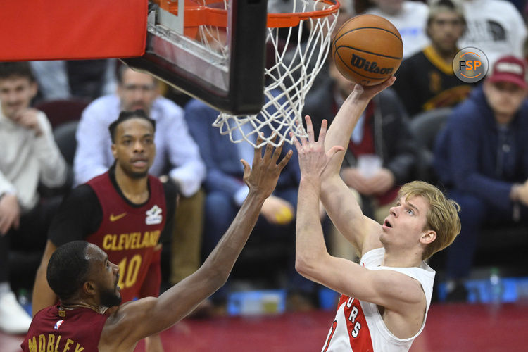 Jan 9, 2025; Cleveland, Ohio, USA; Toronto Raptors guard Gradey Dick (1) shoots as Cleveland Cavaliers forward Evan Mobley (4) defends in the fourth quarter at Rocket Mortgage FieldHouse. Credit: David Richard-Imagn Images