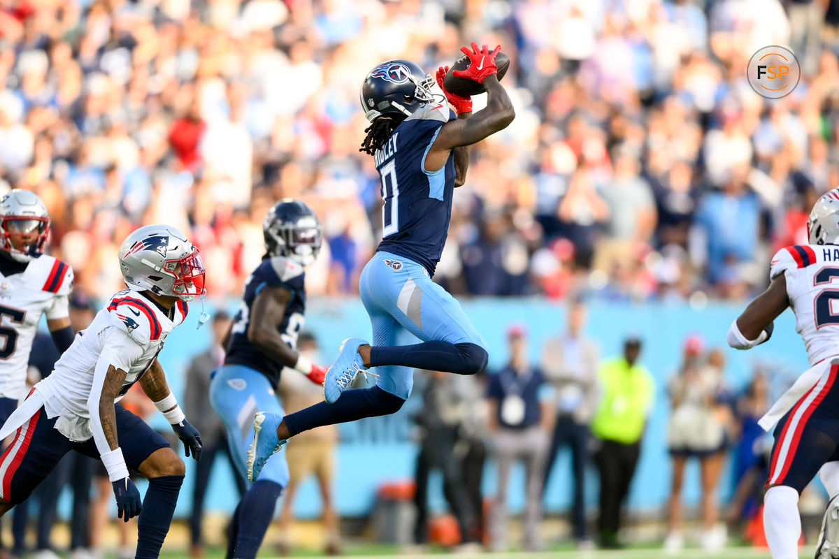 Nov 3, 2024; Nashville, Tennessee, USA;  Tennessee Titans wide receiver Calvin Ridley (0) makes a catch between New England Patriots safety Jaylinn Hawkins (21) and New England Patriots cornerback Christian Gonzalez (0) during the second half at Nissan Stadium. Credit: Steve Roberts-Imagn Images