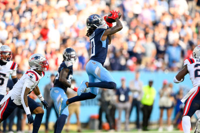 Nov 3, 2024; Nashville, Tennessee, USA;  Tennessee Titans wide receiver Calvin Ridley (0) makes a catch between New England Patriots safety Jaylinn Hawkins (21) and New England Patriots cornerback Christian Gonzalez (0) during the second half at Nissan Stadium. Mandatory Credit: Steve Roberts-Imagn Images