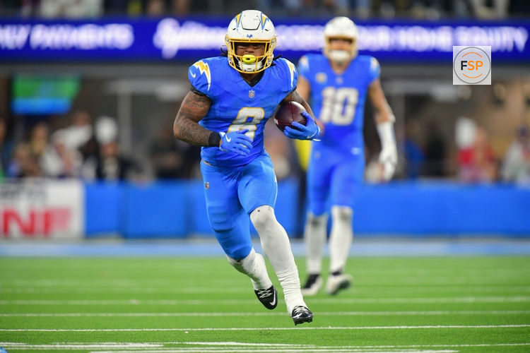 Dec 8, 2025; Inglewood, California, USA;  Los Angeles Chargers running back Omarion Hampton (8) runs against the Philadelphia Eagles in overtime at SoFi Stadium. Credit: Gary A. Vasquez-Imagn Images