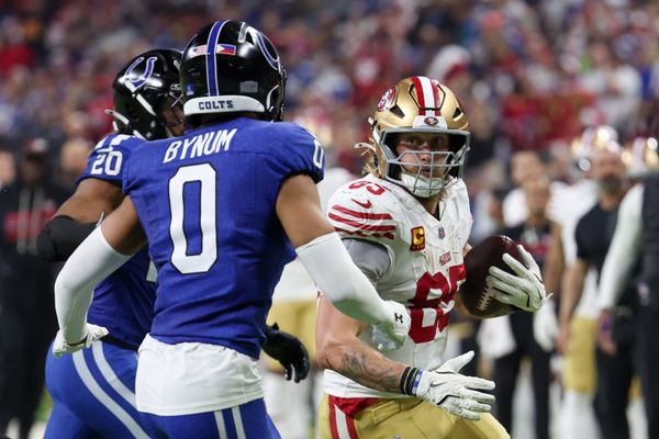 Dec 22, 2025; Indianapolis, Indiana, USA; San Francisco 49ers tight end George Kittle (85) carries the ball defended by Indianapolis Colts safety Nick Cross (20) and safety Cam Bynum (0) in the third quarter of the game at Lucas Oil Stadium. Mandatory Credit: Trevor Ruszkowski-Imagn Images