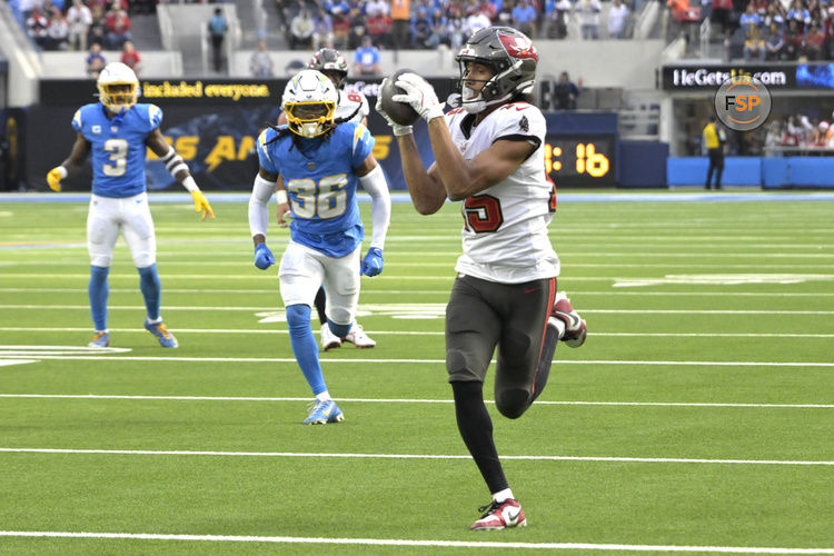 Dec 15, 2024; Inglewood, California, USA;  Tampa Bay Buccaneers wide receiver Jalen McMillan (15) catches a pass and runs into the end zone for a touchdown in the first half at against the Los Angeles Chargers at SoFi Stadium. Credit: Jayne Kamin-Oncea-Imagn Images