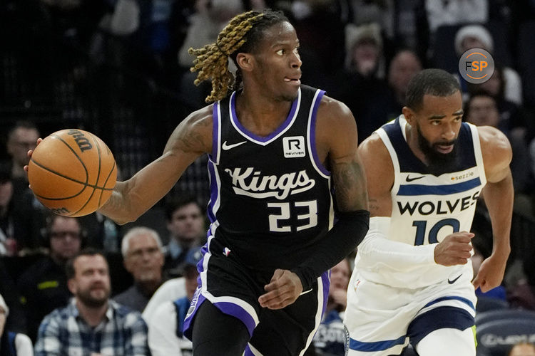 Feb 3, 2025; Minneapolis, Minnesota, USA; Sacramento Kings guard Keon Ellis (23) brings the ball up court after stealing it from the Minnesota Timberwolves in the third quarter at Target Center. Credit: Bruce Kluckhohn-Imagn Images