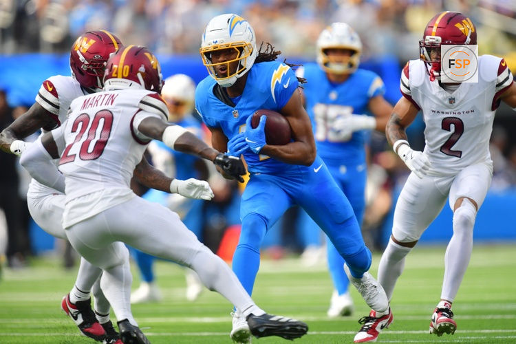 Oct 5, 2025; Inglewood, California, USA; Los Angeles Chargers wide receiver Quentin Johnston (1) runs against Washington Commanders safety Quan Martin (20) in the first half at SoFi Stadium. Credit: Gary A. Vasquez-Imagn Images