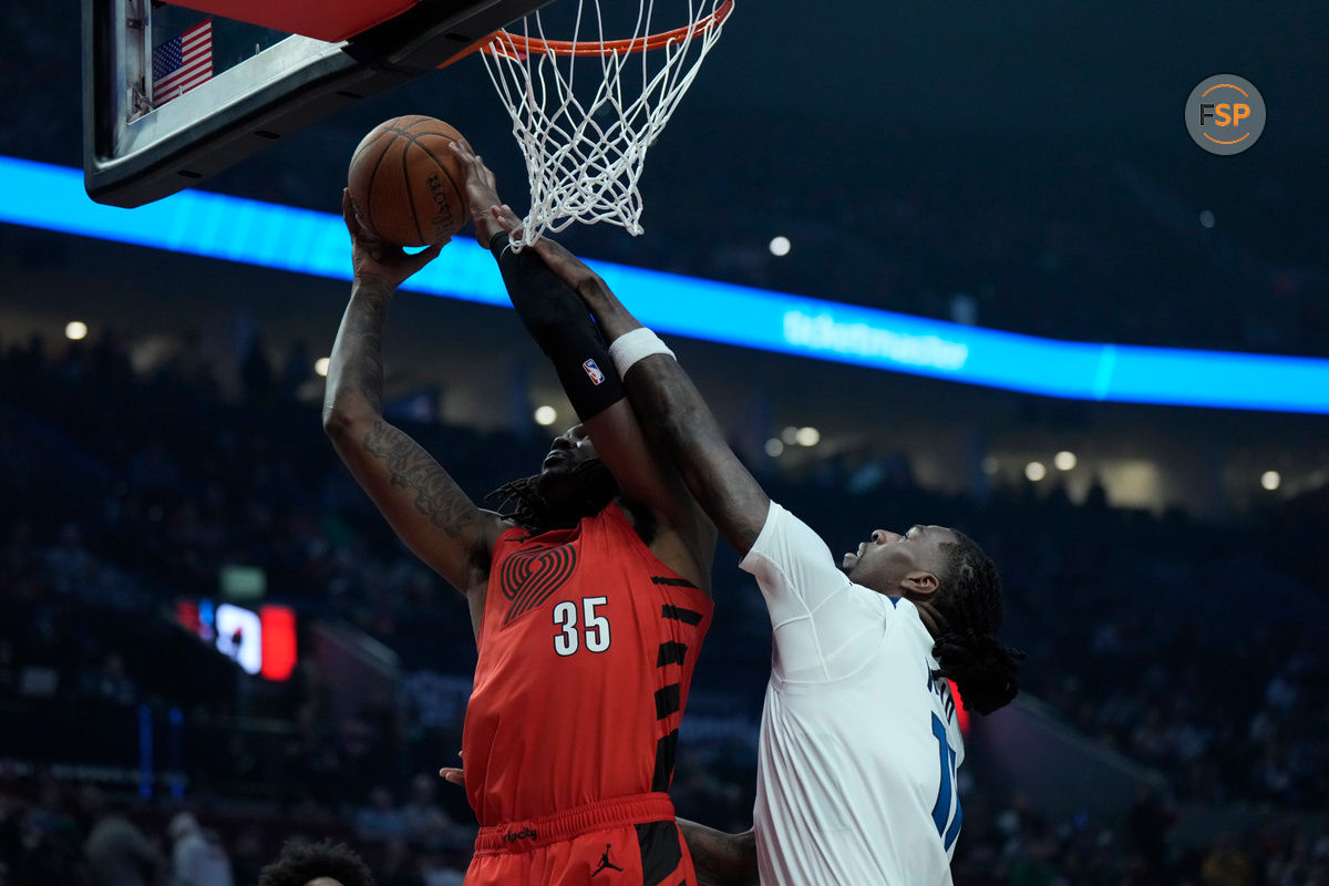 Nov 12, 2024; Portland, Oregon, USA; Portland Trail Blazers center Robert Williams III (35) shoots the ball against Minnesota Timberwolves center Naz Reid (11) during the first half at Moda Center. Credit: Soobum Im-Imagn Images