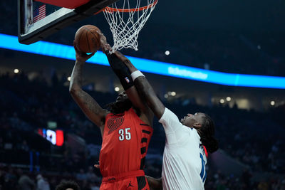 Nov 12, 2024; Portland, Oregon, USA; Portland Trail Blazers center Robert Williams III (35) shoots the ball against Minnesota Timberwolves center Naz Reid (11) during the first half at Moda Center. Mandatory Credit: Soobum Im-Imagn Images