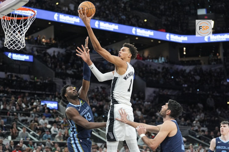Jan 17, 2025; San Antonio, Texas, USA; San Antonio Spurs center Victor Wembanyama (1) shoots in between Memphis Grizzlies forwards Jaren Jackson Jr. (13) and Santi Aldama (7) in the second half at Frost Bank Center. Credit: Daniel Dunn-Imagn Images