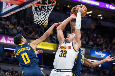 Feb 24, 2025; Indianapolis, Indiana, USA; Denver Nuggets forward Aaron Gordon (32) shoots the ball while Indiana Pacers guard Tyrese Haliburton (0) and forward Aaron Nesmith (23) defend in the second half at Gainbridge Fieldhouse. Mandatory Credit: Trevor Ruszkowski-Imagn Images