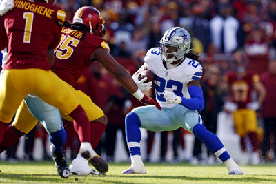 Nov 24, 2024; Landover, Maryland, USA; Dallas Cowboys running back Rico Dowdle (23) runs the ball against Washington Commanders defensive tackle Jer'Zhan Newton (95) during the first quarter at Northwest Stadium. Mandatory Credit: Peter Casey-Imagn Images