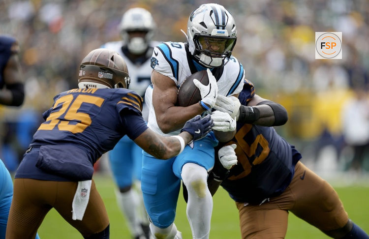 Nov 2, 2025; Green Bay, Wisconsin, USA; Carolina Panthers running back Chuba Hubbard (30) runs against Green Bay Packers cornerback Keisean Nixon (25) during the second half at Lambeau Field. Credit: Jeff Hanisch-Imagn Images