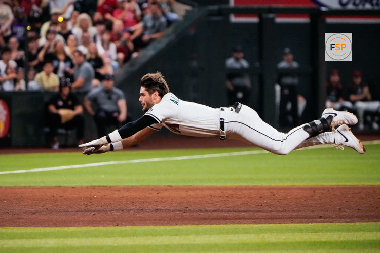 Sep 1, 2025; Phoenix, Arizona, USA;  Arizona Diamondbacks centerfielder Blaze Alexander (9) goes sliding into third base in the sixth inning during the game between the Texas Rangers and Arizona Diamondbacks at Chase Field. Credit: Arianna Grainey-Imagn Images