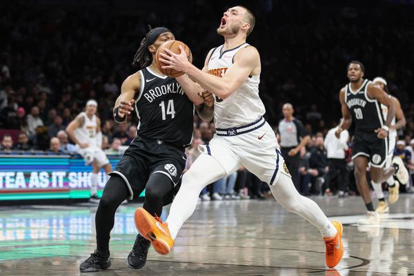 Jan 4, 2026; Brooklyn, New York, USA;  Denver Nuggets guard Christian Braun (0) looks to drive past Brooklyn Nets guard Terance Mann (14) in the first quarter at Barclays Center. Mandatory Credit: Wendell Cruz-Imagn Images