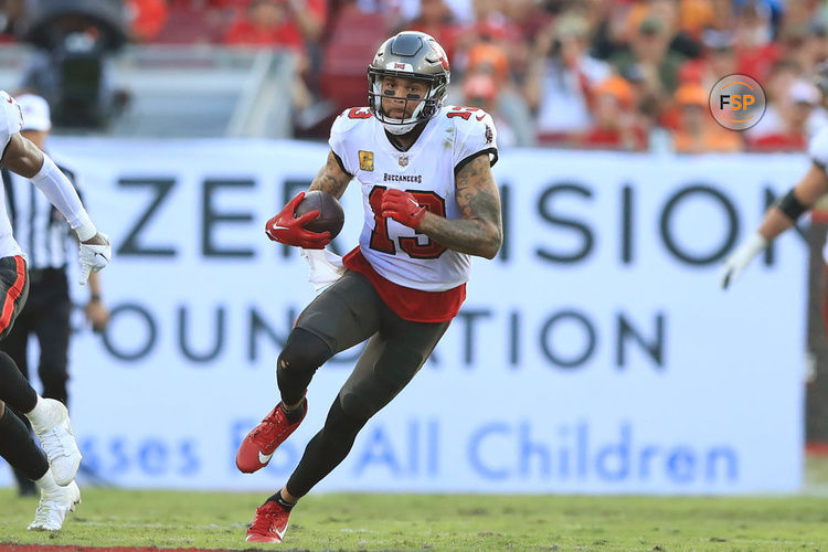 TAMPA, FL - NOVERMBER 12: Tampa Bay Buccaneers Wide Receiver Mike Evans (13) runs with the ball after making the catch during the regular season game between the Tennessee Titans and the Tampa Bay Buccaneers on November 12, 2023 at Raymond James Stadium in Tampa, Florida. (Photo by Cliff Welch/Icon Sportswire)