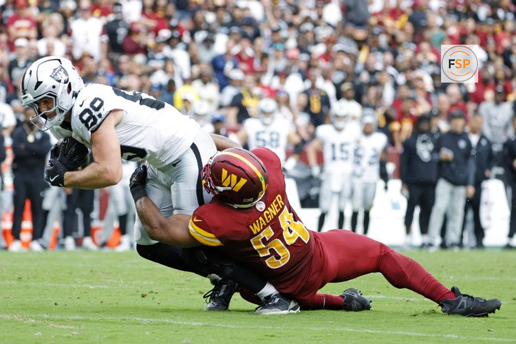 Sep 21, 2025; Landover, Maryland, USA; Las Vegas Raiders tight end Brock Bowers (89) and Washington Commanders middle linebacker Bobby Wagner (54) collide during the second half at Northwest Stadium. Credit: Amber Searls-Imagn Images
