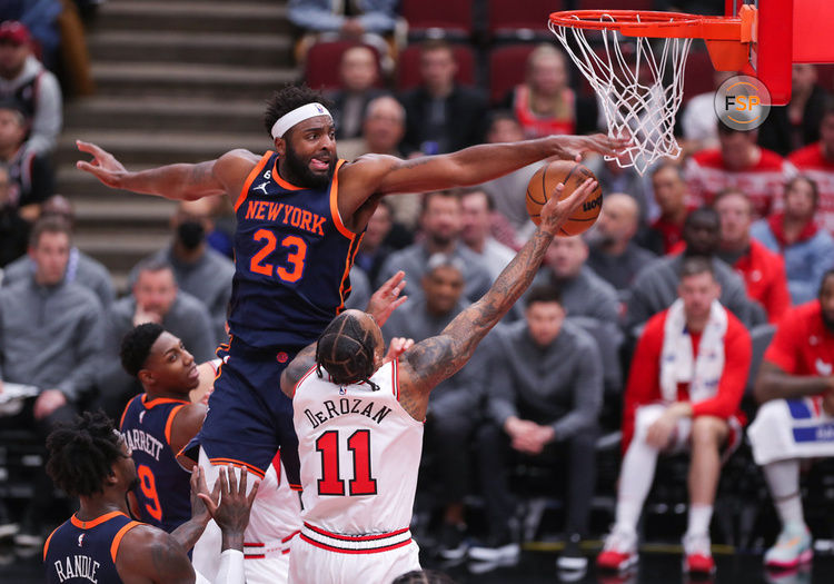 CHICAGO, IL - DECEMBER 14: New York Knicks Center Mitchell Robinson (23) blocks Chicago Bulls Forward DeMar DeRozan (11) shot during a NBA game between the New York Knicks and the Chicago Bulls on December  14, 2022 at the United Center in Chicago, IL. (Photo by Melissa Tamez/Icon Sportswire)