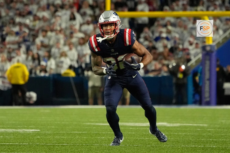 Oct 5, 2025; Orchard Park, New York, USA; New England Patriots running back Treveyon Henderson (32) runs with the ball against the Buffalo Bills during the second half at Highmark Stadium. Credit: Gregory Fisher-Imagn Images