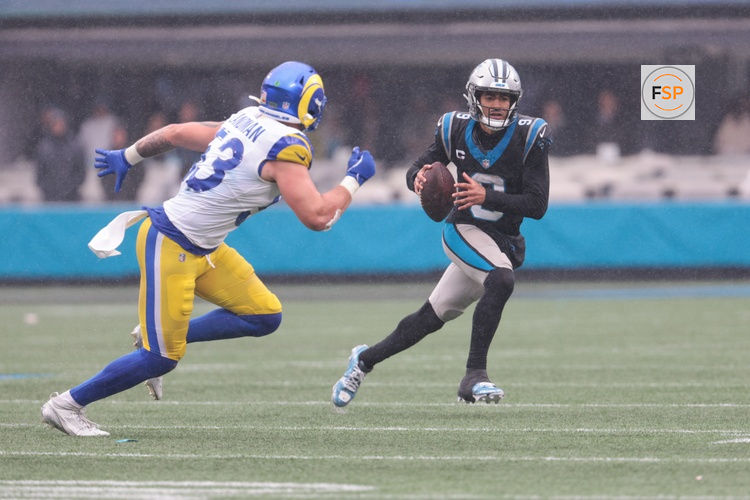 Nov 30, 2025; Charlotte, North Carolina, USA; Carolina Panthers quarterback Bryce Young (9) looks to pass as Los Angeles Rams linebacker Nate Landman (53) defends during the fourth quarter  at Bank of America Stadium. Credit: Scott Kinser-Imagn Images