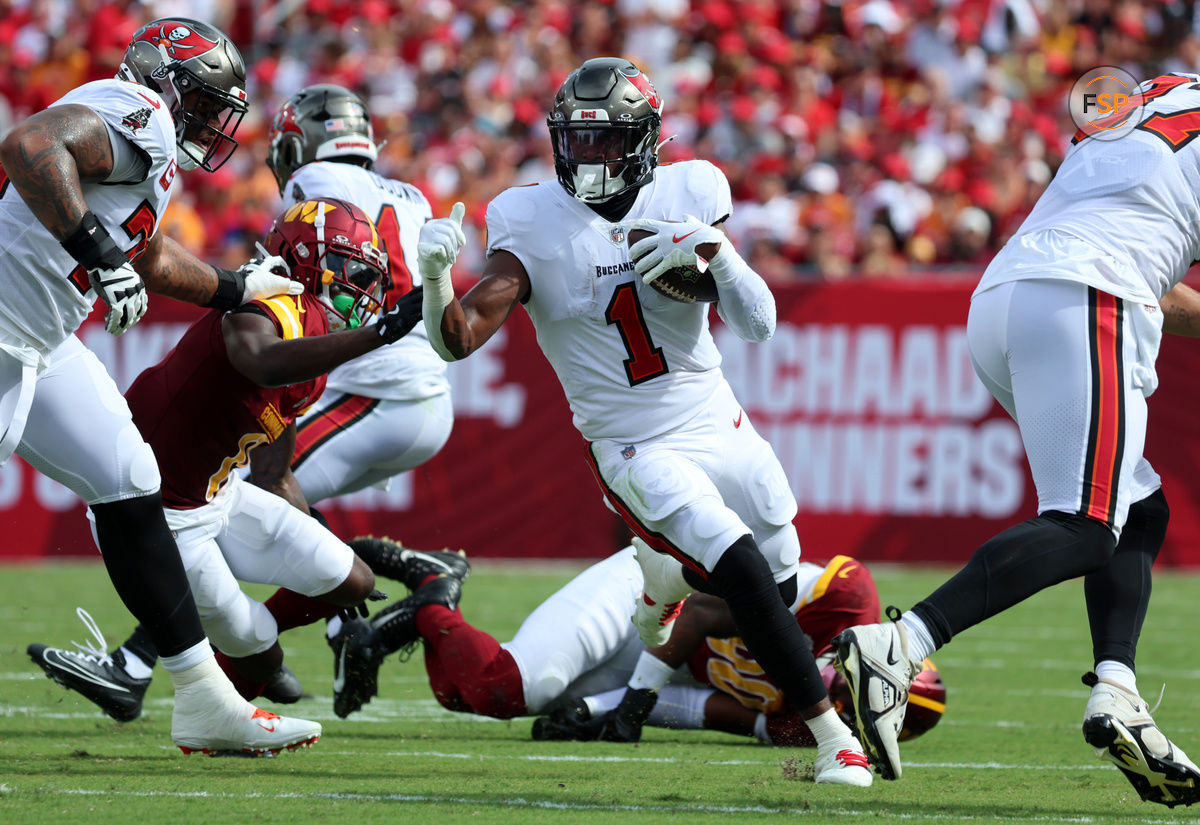 Sep 8, 2024; Tampa, Florida, USA;  Tampa Bay Buccaneers running back Rachaad White (1) runs with the ball against the Washington Commanders during the first quarter at Raymond James Stadium. Credit: Kim Klement Neitzel-Imagn Images