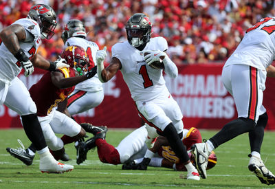 Sep 8, 2024; Tampa, Florida, USA;  Tampa Bay Buccaneers running back Rachaad White (1) runs with the ball against the Washington Commanders during the first quarter at Raymond James Stadium. Mandatory Credit: Kim Klement Neitzel-Imagn Images