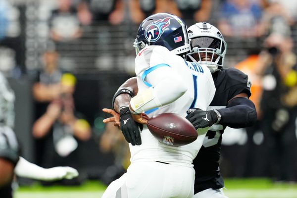 Oct 12, 2025; Paradise, Nevada, USA; Las Vegas Raiders linebacker Devin White (45) hits Tennessee Titans quarterback Cam Ward (1) and causes a fumble during the second half at Allegiant Stadium. Mandatory Credit: Stephen R. Sylvanie-Imagn Images