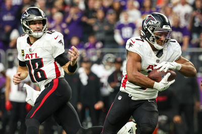 Dec 8, 2024; Minneapolis, Minnesota, USA; Atlanta Falcons running back Bijan Robinson (7) runs the ball for a two-point conversion against the Minnesota Vikings during the third quarter at U.S. Bank Stadium. Mandatory Credit: Matt Krohn-Imagn Images