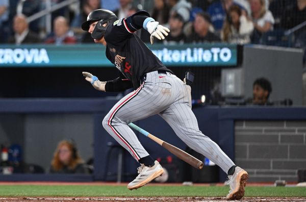 Aug 26, 2025; Toronto, Ontario, CAN;  Minnesota Twins second baseman Luke Keaschall (15) hits a two run home run against the Toronto Blue Jays in the sixth inning at Rogers Centre. Mandatory Credit: Dan Hamilton-Imagn Images