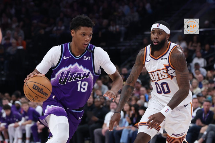 Oct 27, 2025; Salt Lake City, Utah, USA; Utah Jazz guard Ace Bailey (19) drives against Phoenix Suns forward Royce O'Neale (00) during the second half at Delta Center. Credit: Rob Gray-Imagn Images