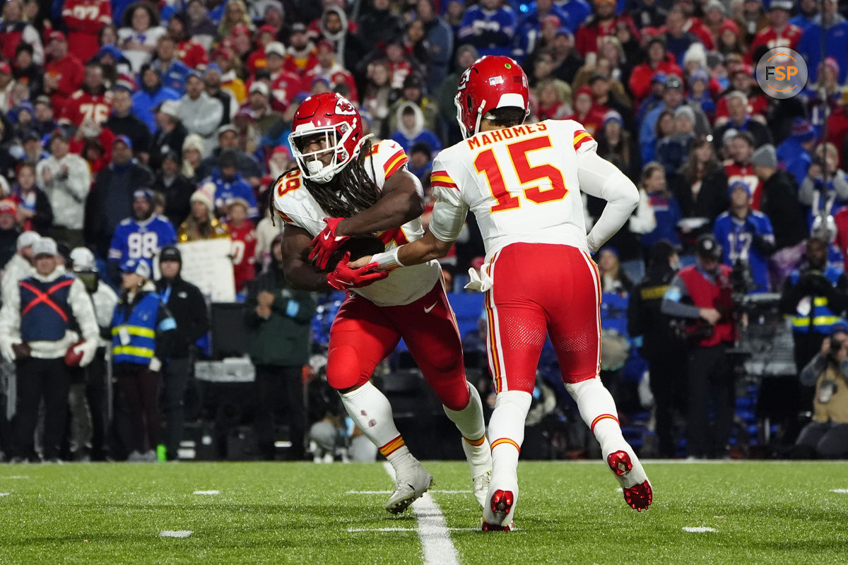 Nov 17, 2024; Orchard Park, New York, USA; Kansas City Chiefs quarterback Patrick Mahomes (15) hands the ball off to Kansas City Chiefs running back Kareem Hunt (29) against the Buffalo Bills during the second half at Highmark Stadium. Credit: Gregory Fisher-Imagn Images