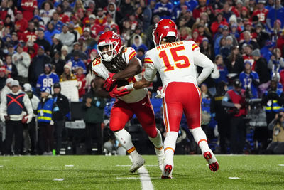 Nov 17, 2024; Orchard Park, New York, USA; Kansas City Chiefs quarterback Patrick Mahomes (15) hands the ball off to Kansas City Chiefs running back Kareem Hunt (29) against the Buffalo Bills during the second half at Highmark Stadium. Mandatory Credit: Gregory Fisher-Imagn Images