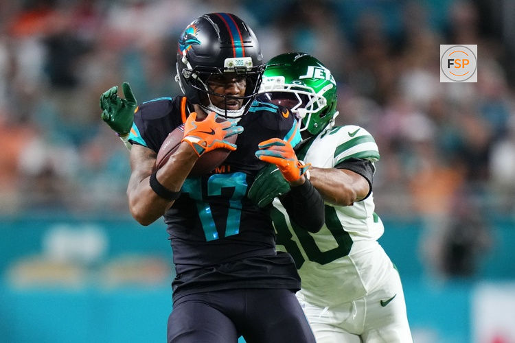 Sep 29, 2025; Miami Gardens, Florida, USA; Miami Dolphins wide receiver Jaylen Waddle (17) makes a catch against New York Jets cornerback Michael Carter II (30) during the first half at Hard Rock Stadium. Credit: Rich Storry-Imagn Images
