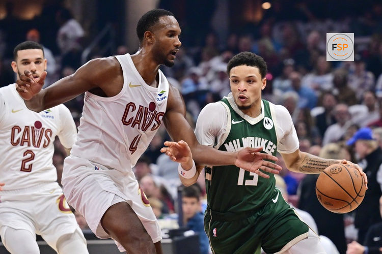 Oct 26, 2025; Cleveland, Ohio, USA; Milwaukee Bucks guard Ryan Rollins (13) drives to the basket against Cleveland Cavaliers center Evan Mobley (4) during the first half at Rocket Arena. Credit: Ken Blaze-Imagn Images