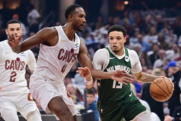 Oct 26, 2025; Cleveland, Ohio, USA; Milwaukee Bucks guard Ryan Rollins (13) drives to the basket against Cleveland Cavaliers center Evan Mobley (4) during the first half at Rocket Arena. Mandatory Credit: Ken Blaze-Imagn Images