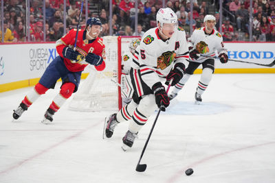 Feb 1, 2025; Sunrise, Florida, USA; Chicago Blackhawks defenseman Connor Murphy (5) clears the zone as Florida Panthers left wing Matthew Tkachuk (19) follows on the play in the second period at Amerant Bank Arena. Mandatory Credit: Jim Rassol-Imagn Images