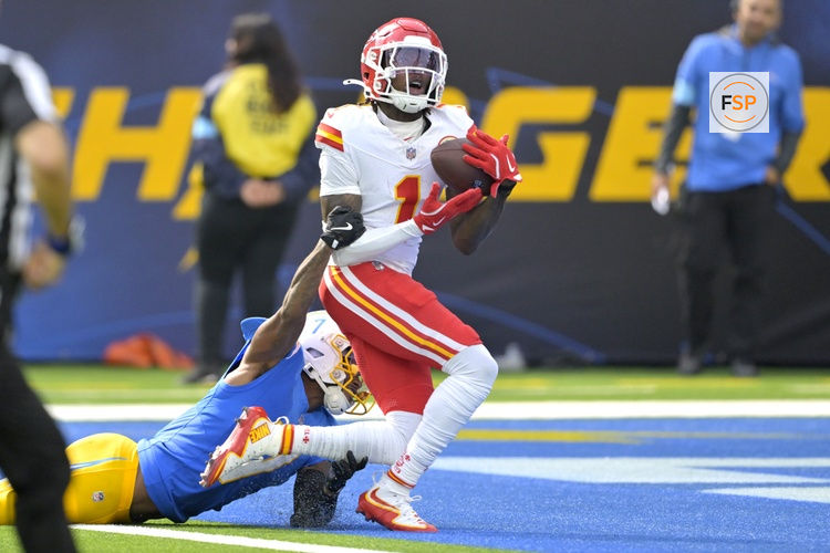Sep 29, 2024; Inglewood, California, USA;  Kansas City Chiefs wide receiver Xavier Worthy (1) is defended by Los Angeles Chargers cornerback Kristian Fulton (7) as he hangs on to a touchdown pass in the first half at SoFi Stadium. Credit: Jayne Kamin-Oncea-Imagn Images