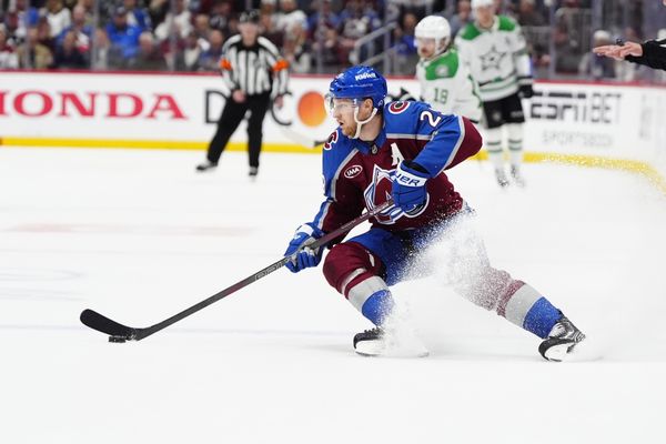 May 1, 2025; Denver, Colorado, USA; Colorado Avalanche center Nathan MacKinnon (29) controls the puck in the second period against the Dallas Stars in game six of the first round of the 2025 Stanley Cup Playoffs at Ball Arena. Mandatory Credit: Ron Chenoy-Imagn Images
