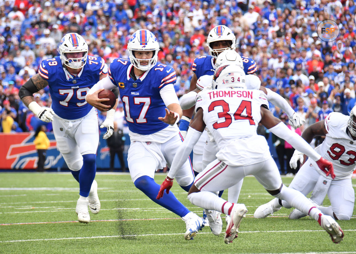 Sep 8, 2024; Orchard Park, New York, USA; Buffalo Bills quarterback Josh Allen (17) tries to avoid a tackle by Arizona Cardinals safety Jalen Thompson (34) in the second quarter at Highmark Stadium. Credit: Mark Konezny-Imagn Images