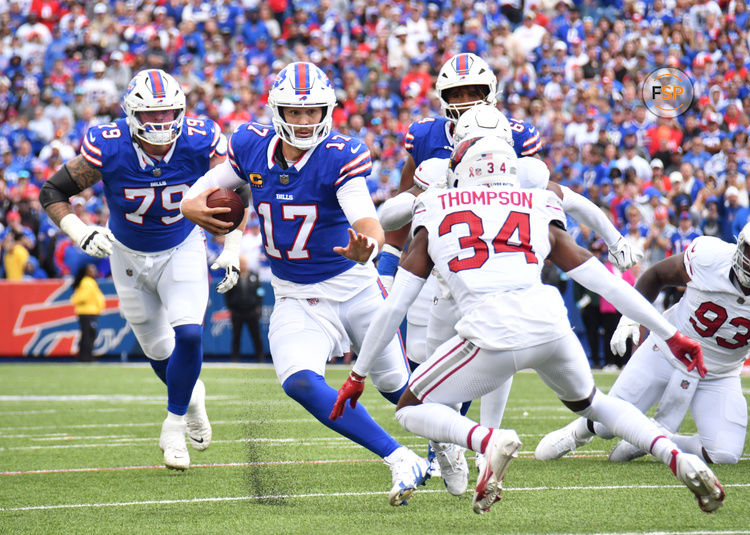 Sep 8, 2024; Orchard Park, New York, USA; Buffalo Bills quarterback Josh Allen (17) tries to avoid a tackle by Arizona Cardinals safety Jalen Thompson (34) in the second quarter at Highmark Stadium. Credit: Mark Konezny-Imagn Images