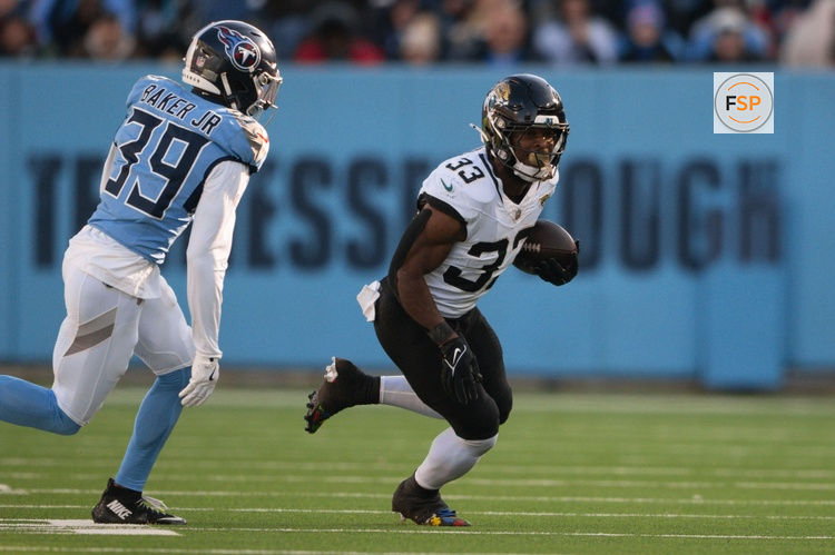 Nov 30, 2025; Nashville, Tennessee, USA;  Jacksonville Jaguars running back Bhayshul Tuten (33) runs with the ball against the Tennessee Titans during the second half at Nissan Stadium. Credit: Steve Roberts-Imagn Images