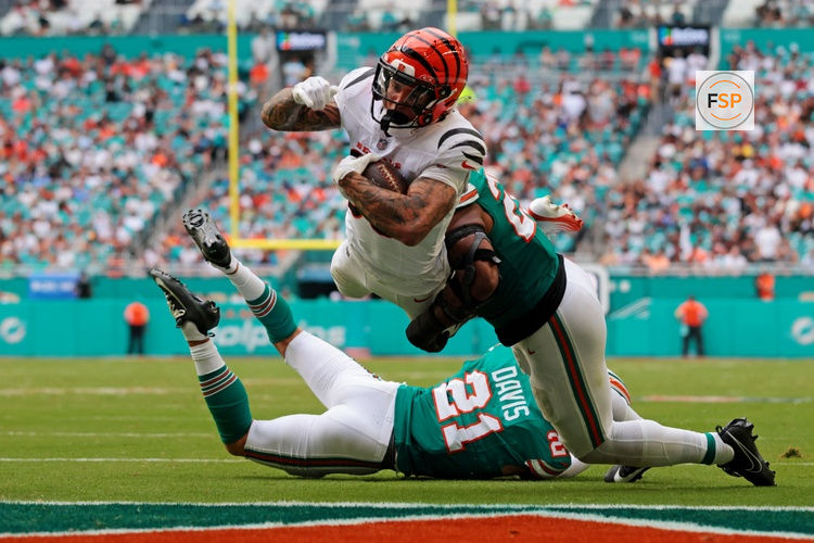 Dec 21, 2025; Miami Gardens, Florida, USA; Cincinnati Bengals running back Chase Brown (30) scores a touchdown during the third quarter against the Cincinnati Bengals at Hard Rock Stadium. Credit: Sam Navarro-Imagn Images