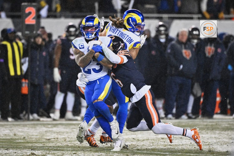 Jan 18, 2026; Chicago, IL, USA; Los Angeles Rams running back Kyren Williams (23) runs with the ball against Chicago Bears cornerback Kyler Gordon (6) during the second quarter of an NFC Divisional Round game at Soldier Field. Credit: Matt Marton-Imagn Images