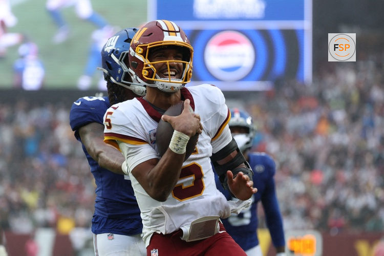 Oct 11, 2026; Landover, Maryland, USA;  Washington Commanders quarterback Jayden Daniels (5) celebrates scoring a touchdown during the fourth quarter against the New York Giants at Northwest Stadium.  Credit: Amber Searls-Imagn Images
