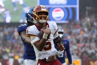 Oct 11, 2026; Landover, Maryland, USA;  Washington Commanders quarterback Jayden Daniels (5) celebrates scoring a touchdown during the fourth quarter against the New York Giants at Northwest Stadium.  Mandatory Credit: Amber Searls-Imagn Images