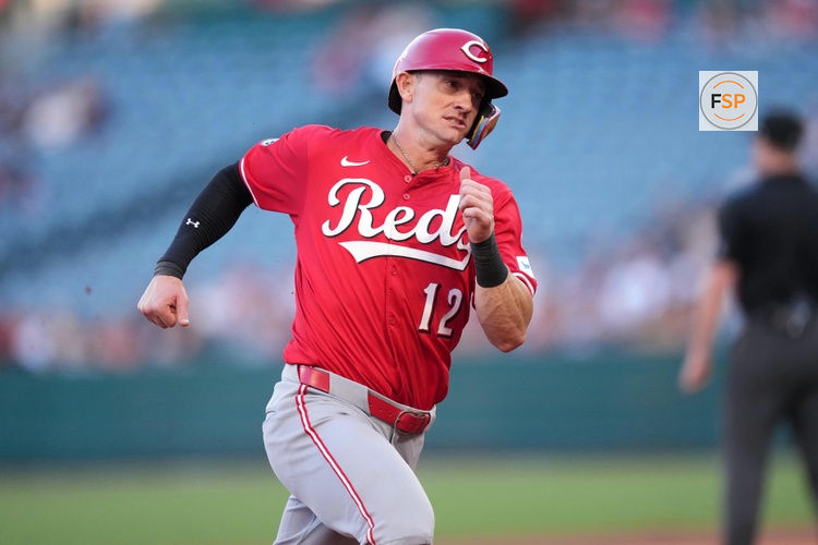 Aug 18, 2025; Anaheim, California, USA; Cincinnati Reds left fielder Austin Hays (12) runs to first base in the first inning against the Los Angeles Angels at Angel Stadium. Credit: Kirby Lee-Imagn Images