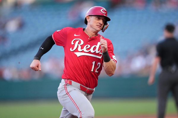 Aug 18, 2025; Anaheim, California, USA; Cincinnati Reds left fielder Austin Hays (12) runs to first base in the first inning against the Los Angeles Angels at Angel Stadium. Mandatory Credit: Kirby Lee-Imagn Images