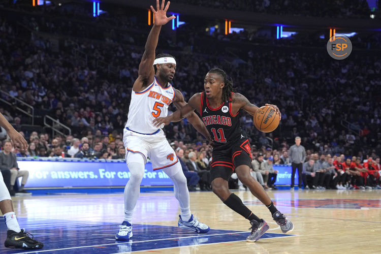 Feb 20, 2025; New York, New York, USA;  Chicago Bulls shooting guard Ayo Dosunmu (11) dribbles the ball against New York Knicks power forward Precious Achiuwa (5) during the first half at Madison Square Garden. Credit: Gregory Fisher-Imagn Images