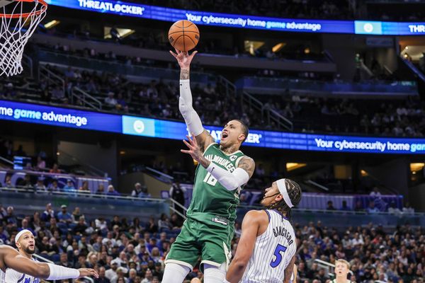 Feb 11, 2026; Orlando, Florida, USA; Milwaukee Bucks forward Kyle Kuzma (18) goes to the basket against Orlando Magic forward Paolo Banchero (5) during the first quarter at Kia Center. Mandatory Credit: Mike Watters-Imagn Images