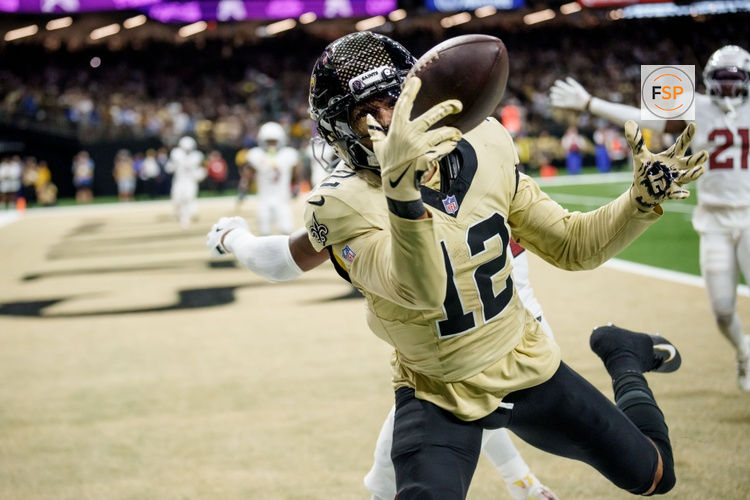 Sep 7, 2025; New Orleans, Louisiana, USA; New Orleans Saints wide receiver Chris Olave (12) tries to reel in a catch for a touchdown but dropped it against the Arizona Cardinals for the last play at Caesars Superdome. Credit: Matthew Hinton-Imagn Images